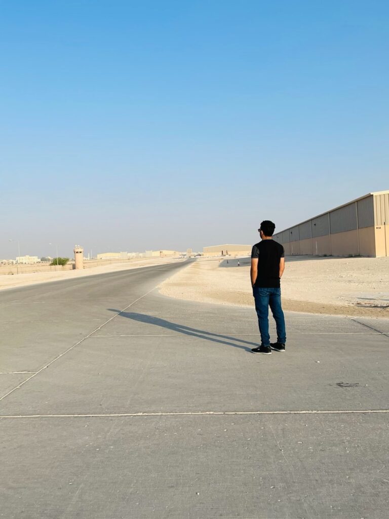 Prince Wafa stands with his back to the camera, looking into the distance