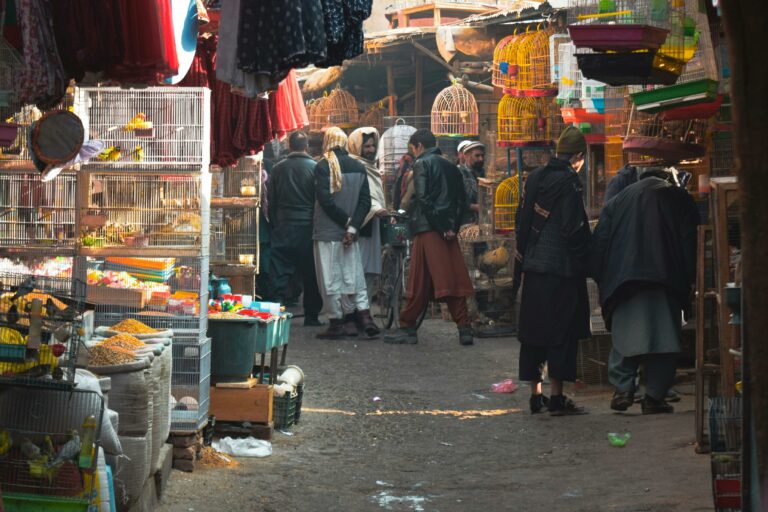 People walk about a market in Khabul